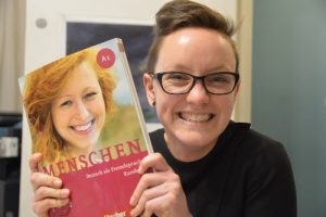 Friendly student with Menschen German textbook